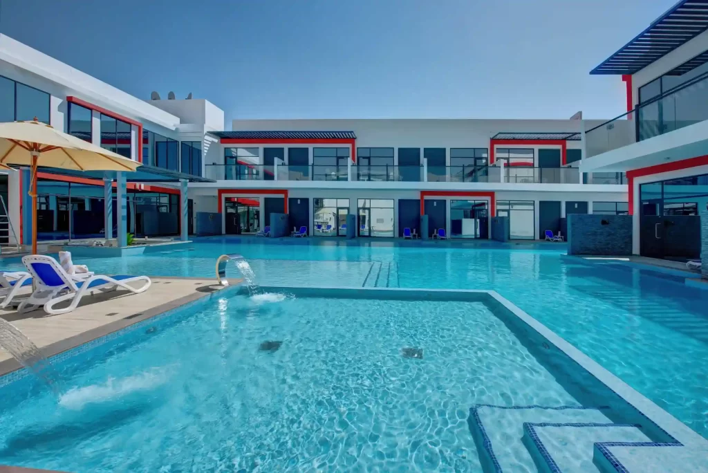 Sparkling pool area at Kay Homes, featuring luxurious lounging spaces and a serene environment.