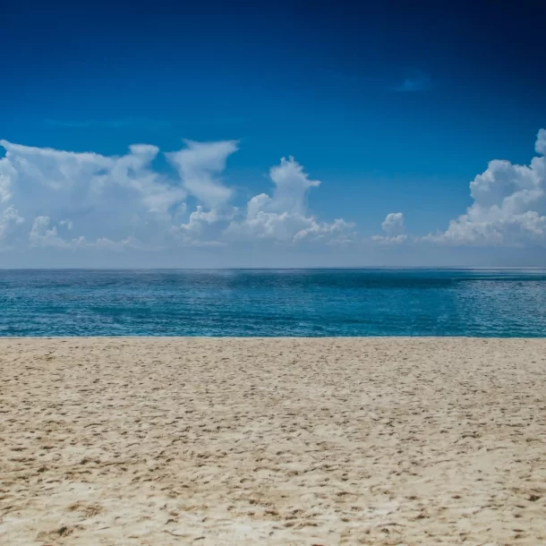 Scenic beach view at Kay Homes, showcasing a beautiful coastal setting for relaxing and enjoying the sun.