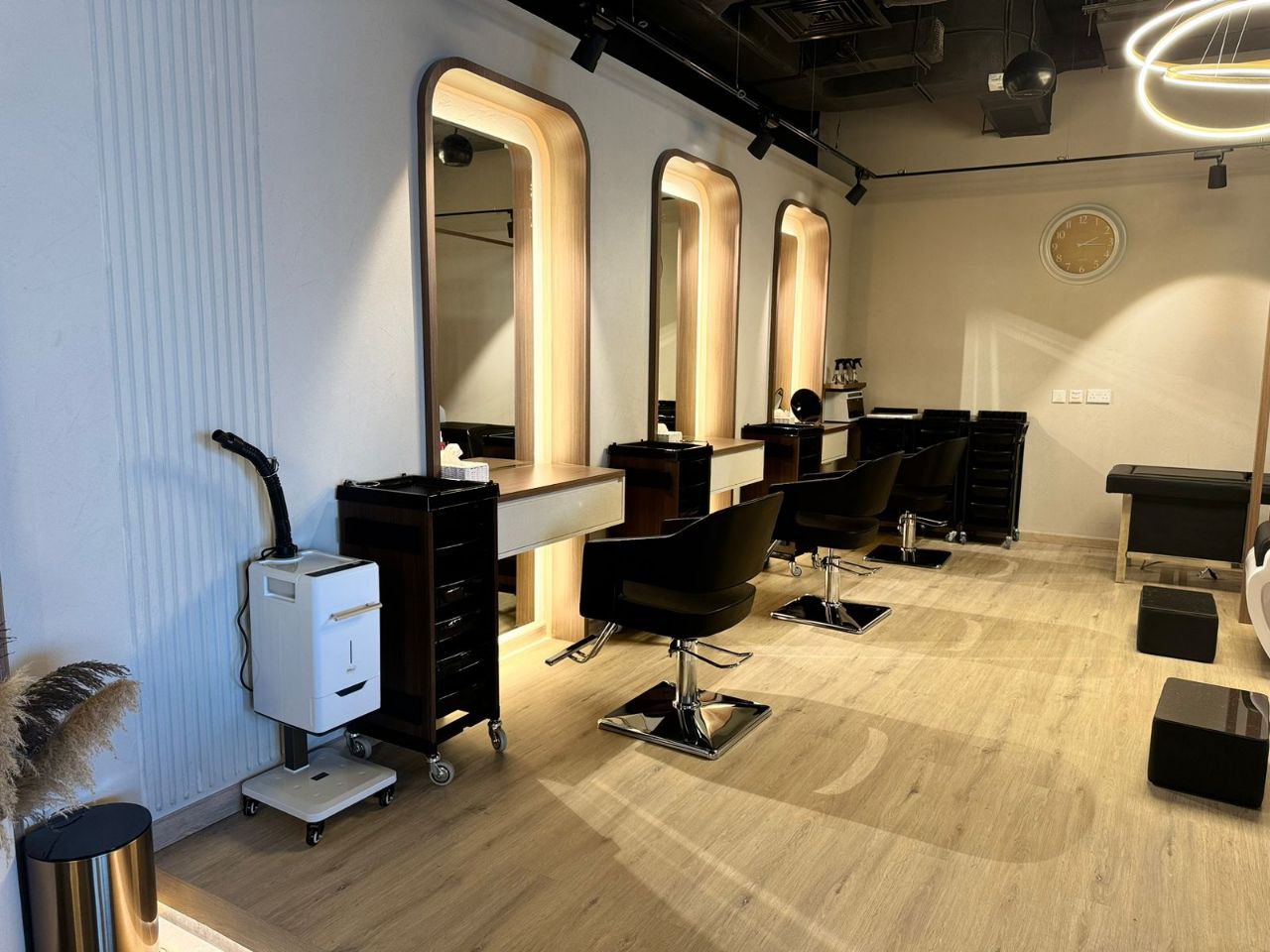 Modern beauty salon interior at Kay Homes, featuring chic styling stations and a contemporary design.